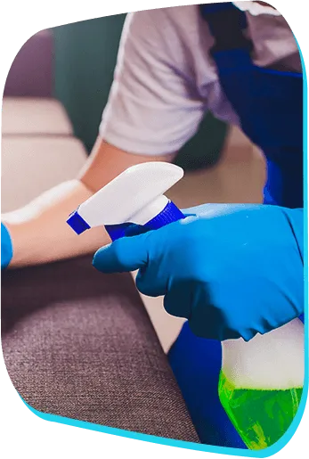 Close-up of a professional wearing blue gloves and using a spray bottle to perform detailed janitorial services and office cleaning in Phoenix, AZ.